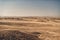 Desert landscape on clear blue sky background. Dune land with dry terrain surface. Ecology and global warming effect