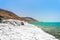 Desert landscape of Dead Sea coastline with white salt, Jordan, Israel.