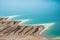 Desert landscape of Dead Sea coastline with white salt, Jordan, Israel.