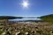 Desert landscape with a lake with little water and a drought environment without rain, dry land and rocks