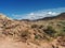 Desert landscape with large rocks in foreground and mountains