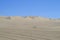 Desert landscape with vast sand dunes in the horizon. Huacachina, Peru.