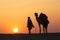 A desert local walks a camel through Thar Desert