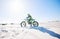 Desert, motorbike and man outdoor for sport, adventure and travel on mockup space. Offroad, sand and driver on