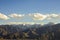 A desert mountain valley with snowy peaks with clouds