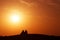 Desert nomads on the crest of a barchan at sunset