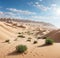 A desert oasis surrounded by towering sand dunes.