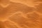 Desert orange sand dunes top view close up, yellow sand texture ornament, desert barchans background