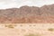 Desert, red mountains, rocks and cloudy sky. Egypt, color canyon