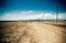 Desert road across arizona with electricity posts, usa