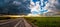 Desert road under a dramatic sky