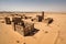 desert ruin being overtaken by the sands of time, with only angular buildings and walls visible