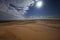 Desert sand dunes, clouds and bright sun