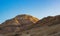 Desert sand stone mountains landscape in morning sun rise lighting scenic view in Middle East region, clean blue sky backgrund