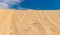 Desert sands against blue sky