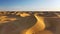 Desert scene in Inner Mongolia, China. Sunlight on rolling dunes, rotating shot