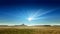 A desert scenery with sun rays in the blue sky