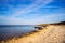 Desert shore of the black sea and picturesque sky .