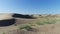 Desert in the spring. Dunes with rare grass. Filmed by drone