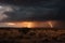 desert storm with lightning and thunder, illuminating the distant storm clouds