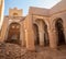 Desert town of Mhamid, Morocco village with sand dunes and old muslim mosque in north Africa, old narrow streets, traditional clay