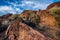 Desert valley plants, rocks, boulders with distant mountain range