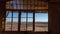 Desert view through on of the neglected window frames of a house at the ghost town of Kolmanskop, Namibia