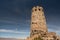 Desert View Tower Stands Tall Against A Blue Sky With Wispy Clouds