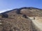 Desert volcanic landscape with lonely hiker climbing on volcano pico del teide with Huevos del Teide Eggs of Teide accretionary