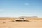 Desert Wasteland with Abandoned Vehicle.