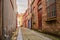 Deserted alley lined with brick buildings