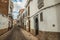 Deserted alley with old terraced buildings and worn plaster in Caceres