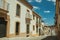 Deserted alley in slope and old buildings with terraces at Caceres