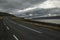 A deserted asphalt road running away into the hills. Iceland. The spirit of travel and adventure.