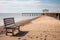 Deserted autumn beach with a bench