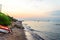 Deserted Beach with Calm Sea and Coast with Pebbles, Sand and Rocks at Sunset. Few People Enjoy the Clear Waters