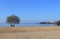 Deserted beach with a football goal. Sandy beach on the lake. End of the beach season.