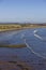 The deserted beach of Lunan Bay looking North with rocky outcrops exposed by the receding tide.