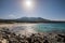 Deserted Bodri beach in Corsica with rocky shoreline