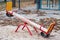 Deserted child swing on playground outdoors. Child amusement outdoor. Equipment for games