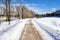 Deserted Cleared Path through a Park Covered in Snow