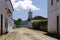 Deserted cobblestone street with church and sea