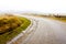 Deserted country road in the autumn fog. The Netherlands, Texel Island