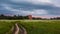 Deserted country road in the field on the sunset