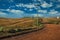 Deserted dirt road passing through rural lowlands