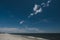 Deserted empty sandy beach in sunshine, blue skies and clouds in Fire Island New York