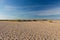Deserted endless beach between some dunes