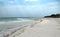 The deserted fairy tale beach with golden sand, beautiful sky and turquoise water on the shores of ocean.