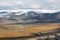 Deserted gravel road across Mongolia steppe towards Gobi