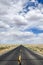 Deserted highway through the desert under cloudy sky